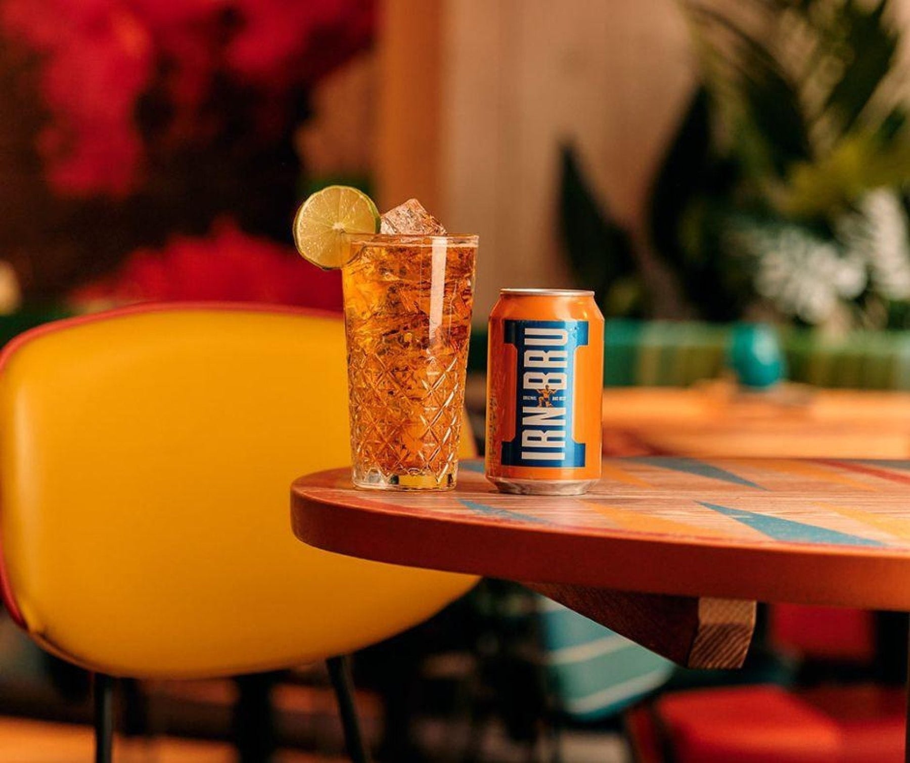 IRN BRU Can next to Glass of IRN BRU drink